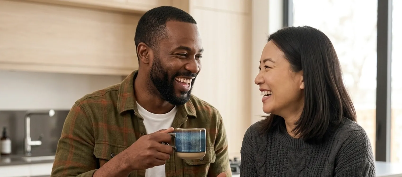 Two people chatting over coffee at home, illustrating Canadians waiting for Foundayo